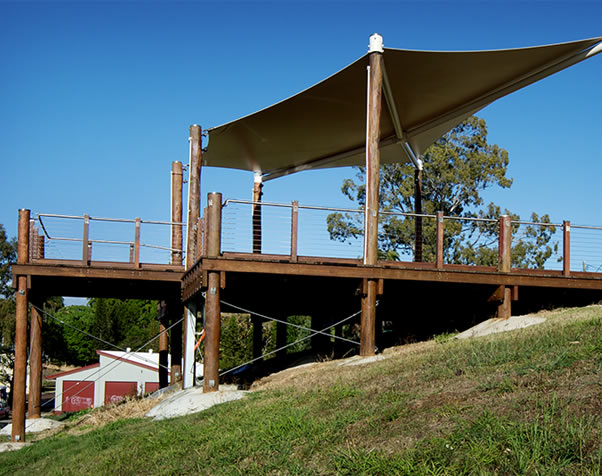 Large image of view from the riverbank observing the height of the poles and the deck construction